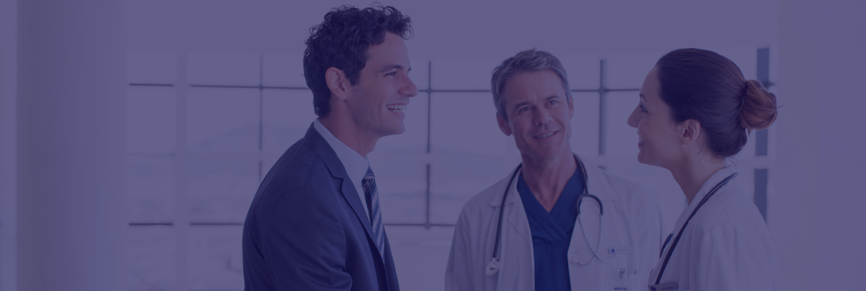 Two docs talking to consultant in hospital